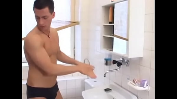 Muscled stud gets fucked bareback in bathroom